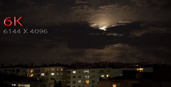 Full Moon And Clouds Over The City