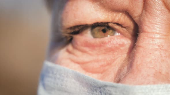 Senior Woman with Medical Mask To Protect Her From Virus