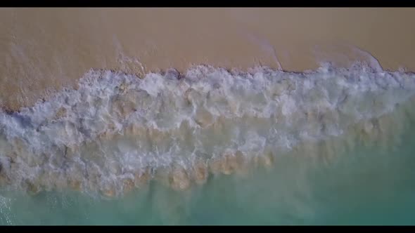 Aerial top down panorama of perfect seashore beach holiday by clear water and bright sandy backgroun