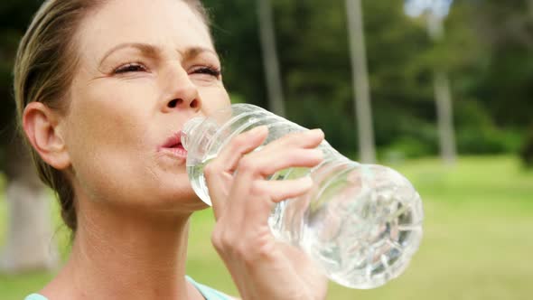 Female athlete drinking water