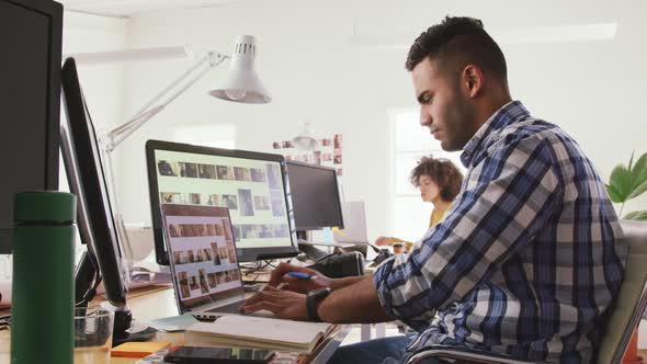 Side view of two colleagues working in creative office