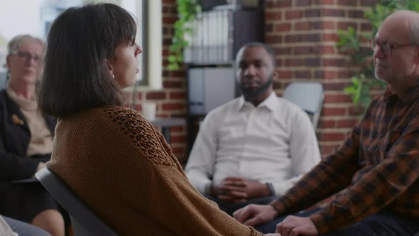 Close Up of Sad Woman Making Confession About Therapy and Addiction at Aa Meeting in Circle