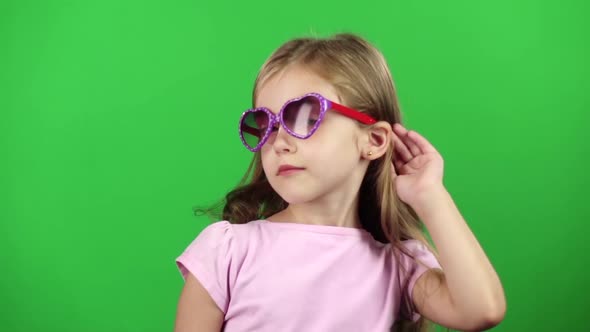 Child Posing for Video Cameras with Glasses. Green Screen. Slow Motion