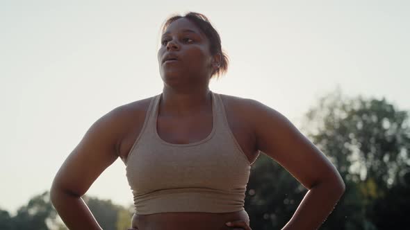 African American woman breathing after the running at the park. Shot with RED helium camera in 8K.