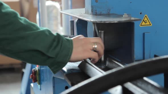 Worker Sawing Detail on Machine. Factory Worker on Circular Saw in Workshop