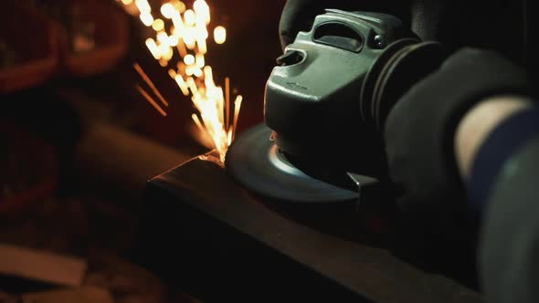 Man Works With Small Electric Grinder.