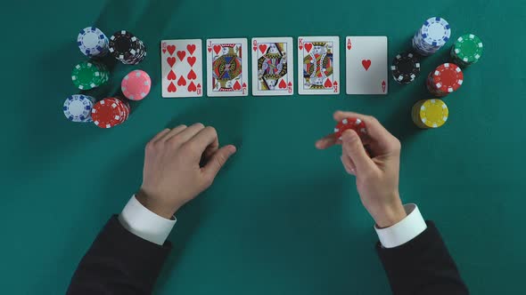 Lucky Man Has Royal Flush Hand, Wins Much Money in Poker Game, Enjoying Success