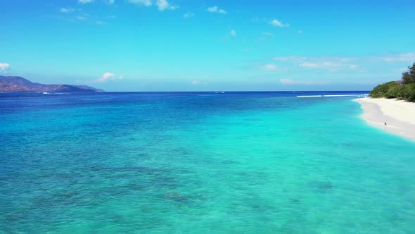 Luxury drone copy space shot of a white sandy paradise beach and aqua blue water background