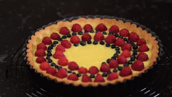 Woman Making Berry Tart with Pudding and Jelly.