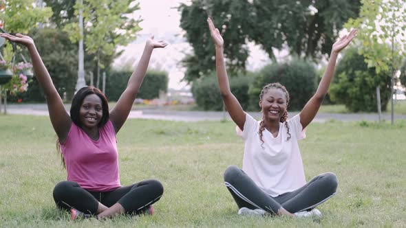 Young African Women Doing Yoga Exercise in a Park