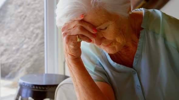 Senior woman sitting sad at home 4k