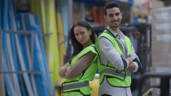 Portrait of Proud Confident Man and Woman Turning Back to Back Crossing Hands Posing in Industrial