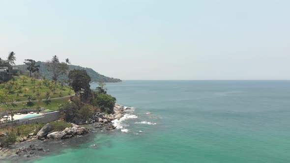 Rocky landscape meeting the Andaman sea parallaxing with the other shoreline