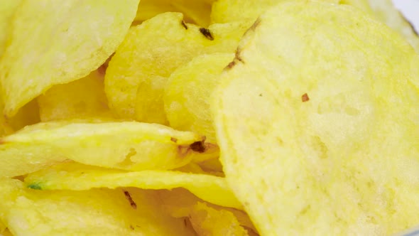 Macro shot of potato chips rotating, close up view in 4k.