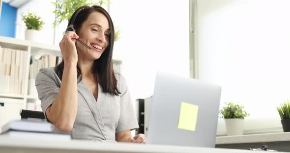 Woman with Headphones and Microphone Communicating Through Laptop Screen  Movie Slow Motion