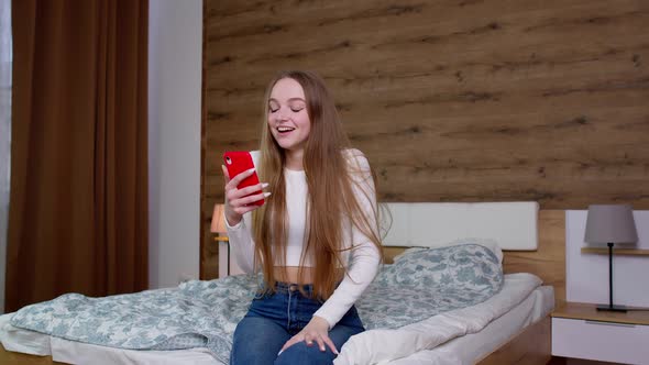 Overjoyed Smiling Young Woman Winner Jumping Dancing at Home Celebrating Mobile Phone Win Success