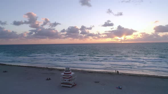 People Enjoying Golden Orange Morning Sunrise On South Beach Miami Aerial