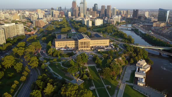 Aerial drone reveal of Philadelphia skyline and Art Museum along Ben Franklin Parkway during a warm