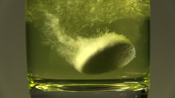 A Tablet Dissolving In Yellow Water