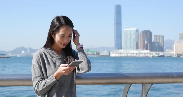 Woman using cellphone in Hong Kong