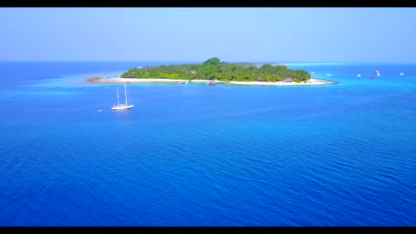 Aerial panorama of tranquil sea view beach break by blue green lagoon with white sandy background of