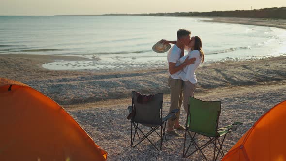 Happy Enamored Travelers Man and Woman Admire Beautiful Sunset on Beach