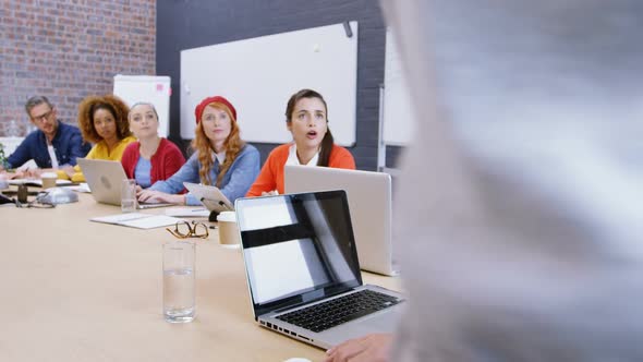 Business executives interacting with each other in meeting