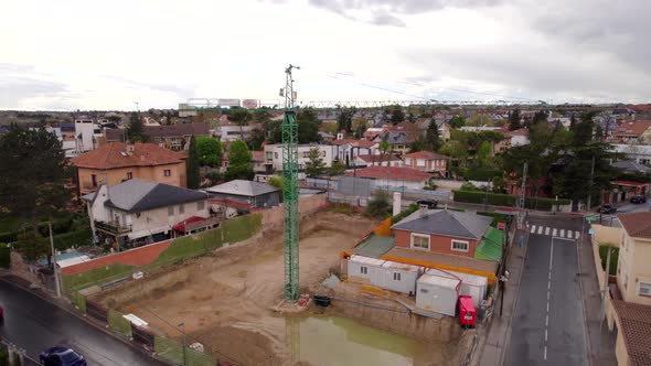 Crane tower in construction project in Spanish neighborhood. Aerial view