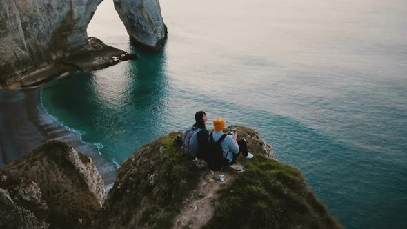 Amazing Cinematic Aerial Shot of Happy Romantic Couple Watching Sunset Sea