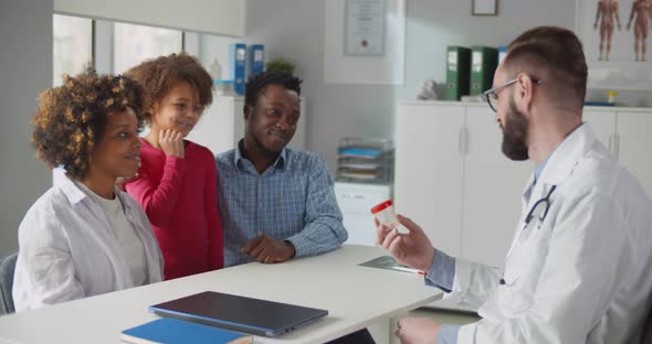 African Parents with Little Daughter Visiting Doctor in Clinic