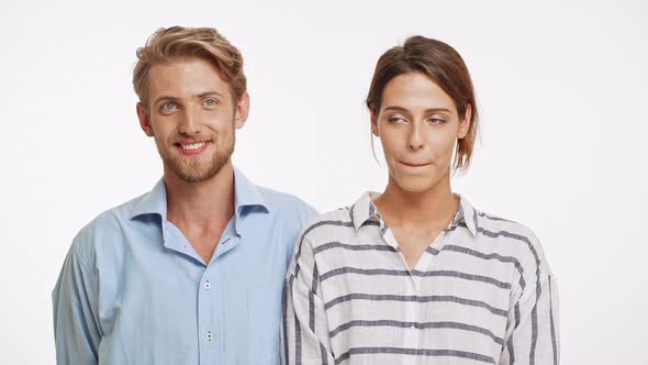 Beautiful Caucasian Pair Standing Flirting Ogle on White Background in Slowmotion