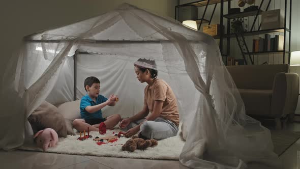 Mother and Kid Playing in Tent House