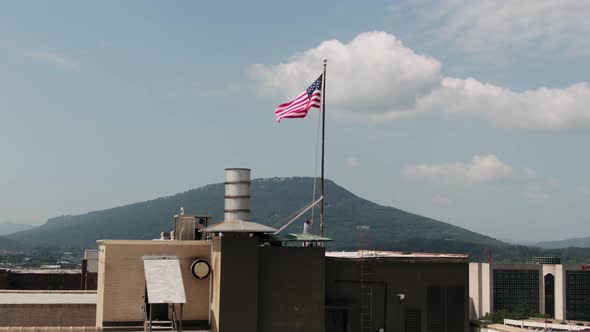 American Flag Stock Video Footage - Withdrawing The American Flag From Its Pole On Top Of A Building