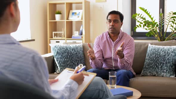 Man and Psychologist at Psychotherapy Session