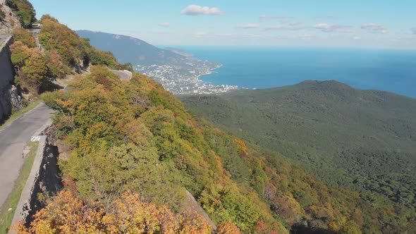 Aerial Shot: Mountain Road and Sea Coastal Town View at Summer Sunny Day