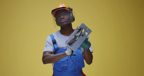 Confident Foreman Standing Against Yellow Background