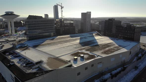 Drone flying upwards towards Hyllie, Emporia. Malmö Arena, Sweden, wintertime