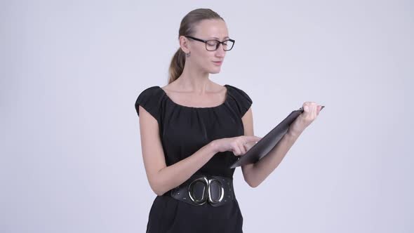 Happy Blonde Businesswoman Showing Clipboard and Giving Thumbs Up