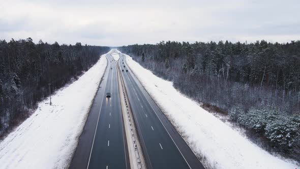 Winter Asphalt Road with Moving Cars Outside the City Aerial View