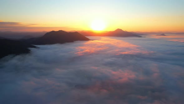 4K Aerial view flying in fog. clouds at sunset fog.