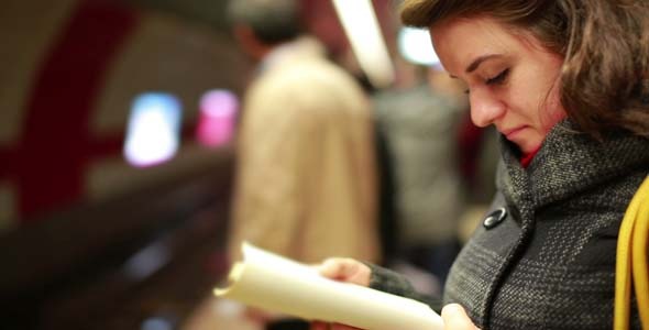 Woman Reading Book At Metro Station