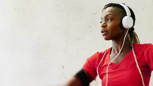 Fit woman exercising with headphones