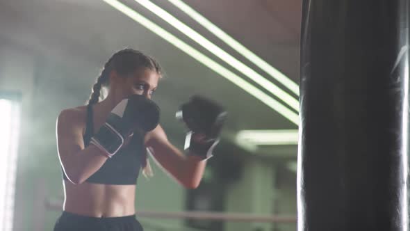 Boxing Woman Fighter Trains His Punches Beats a Punching Bag Training Day in the Boxing Gym Strength