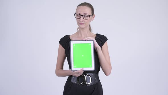 Happy Blonde Businesswoman Thinking While Showing Digital Tablet