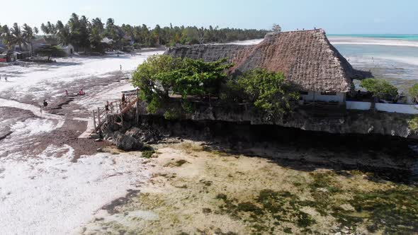 The Rock Restaurant in Ocean Built on Cliff at Low Tide on Zanzibar Aerial View