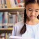 Asian teenager student reading a book in school library. - VideoHive Item for Sale