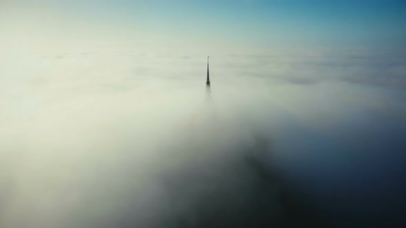 Drone Flying Above Beautiful Clouds Around Epic Heavenly Castle Steeple Top of Mont Saint Michel