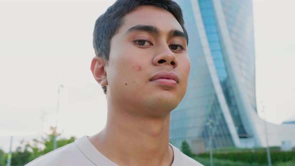 Young asiatic man outdoor looking serious and determined