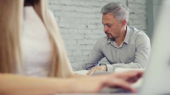 Man Is Writing All Points of New Startup Project at Notebook for Checking All Professional