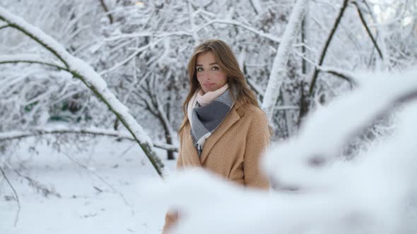 Girl in Snowy Tree Branches